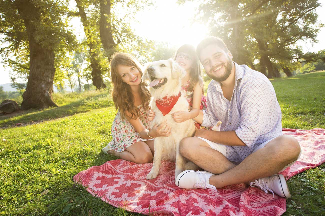 Happy Young Family with their Furry Friend Happy Young Family with their Furry Friend